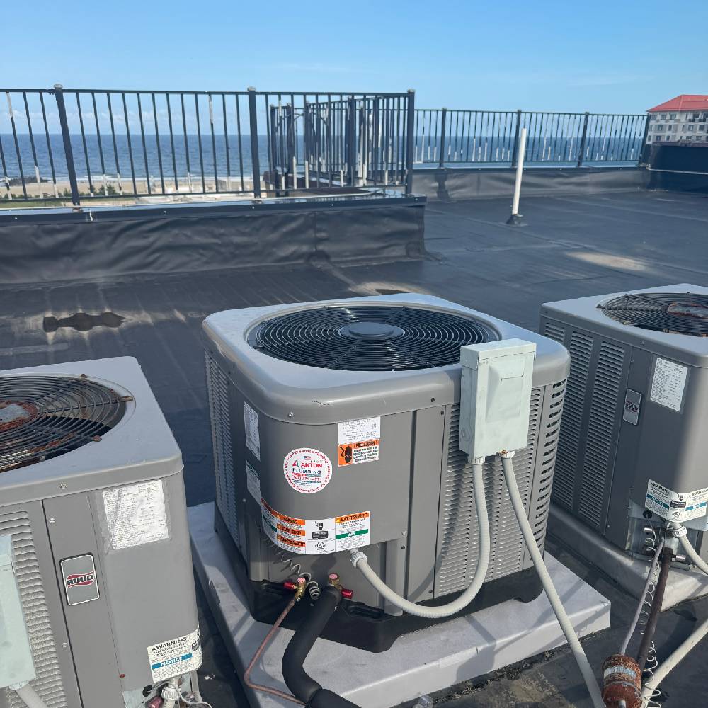 Technician servicing rooftop commercial HVAC unit at Georgetown office building