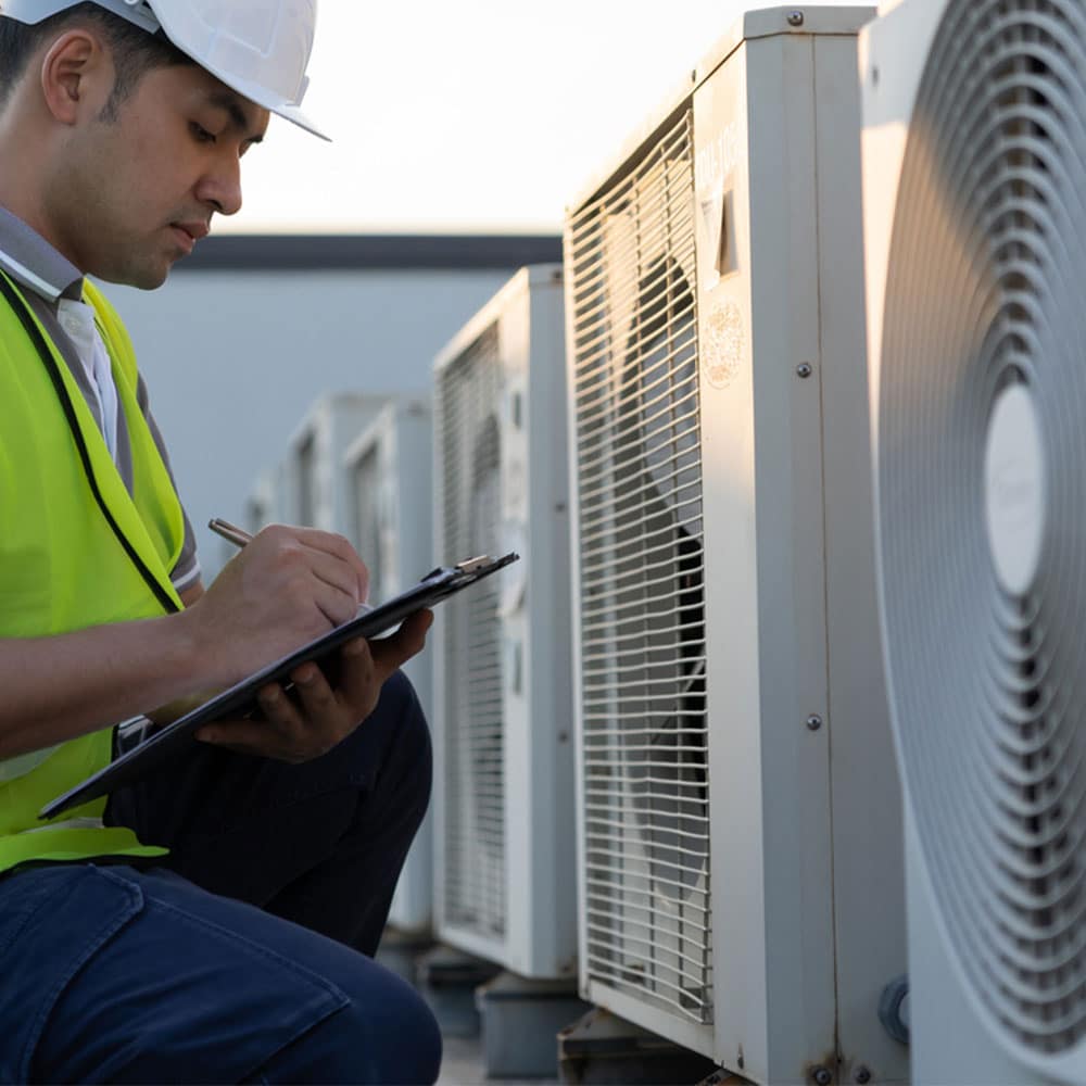 Technician performing seasonal HVAC maintenance at Georgetown home outdoor unit