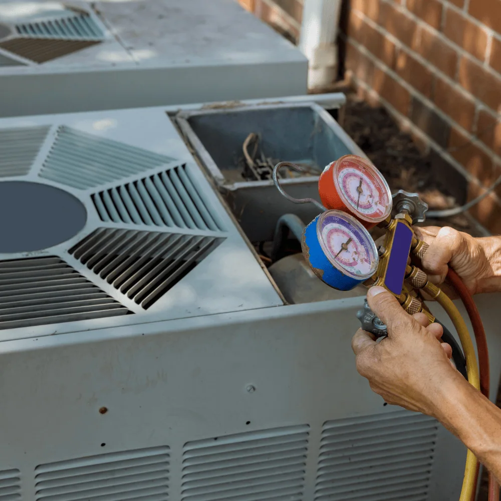 Experienced HVAC technician checking electrical components and airflow during maintenance visit