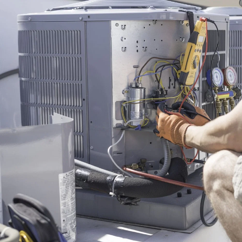 Technician repairing furnace after sudden heating loss in Georgetown family home