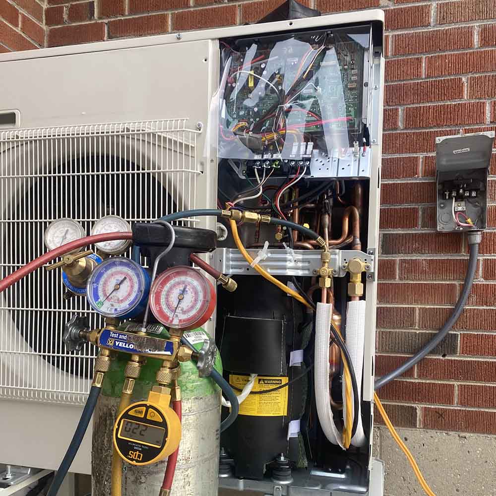 Experienced HVAC technician testing furnace components with diagnostic tools during repair