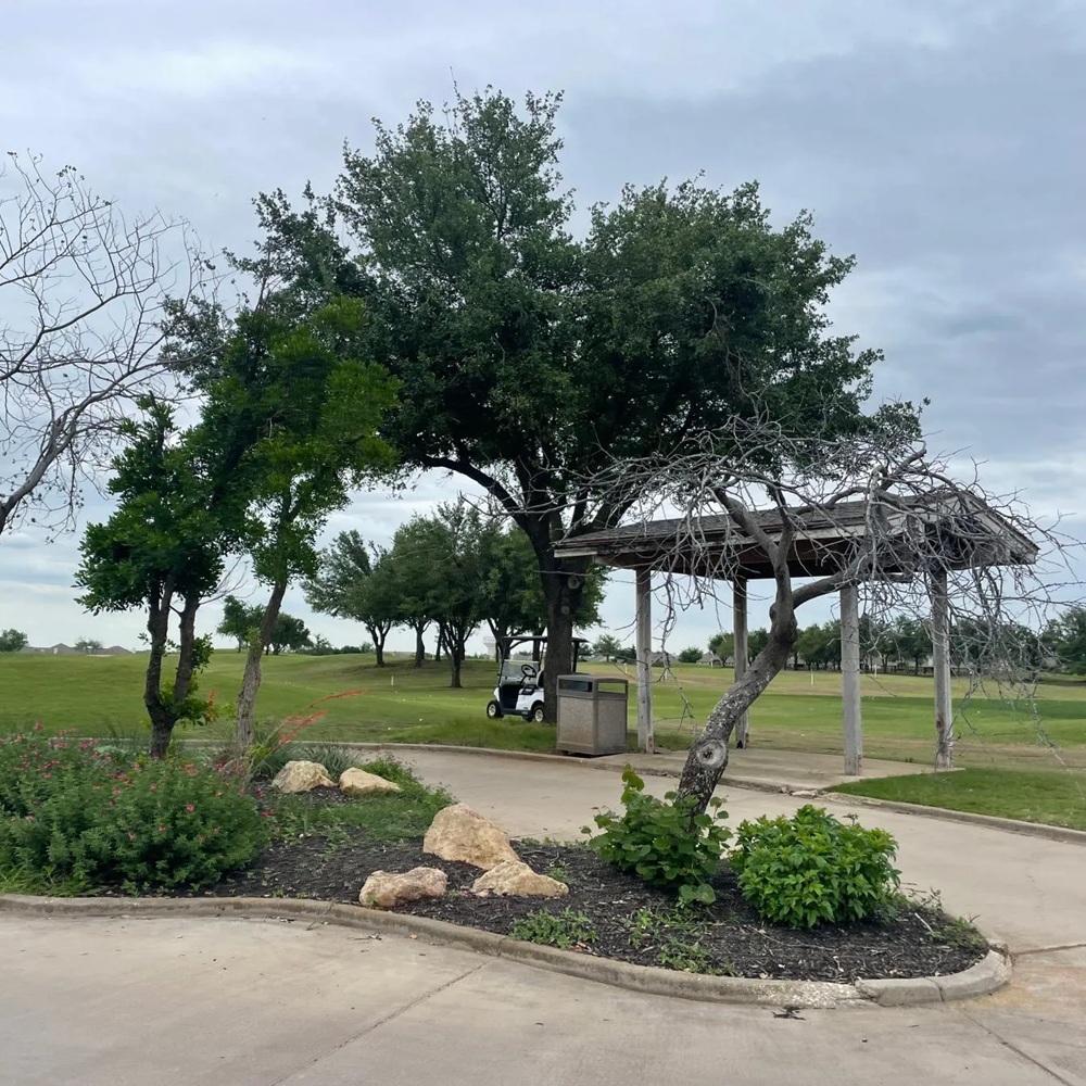 Experienced HVAC technician diagnosing cooling performance with gauges and airflow testing tools