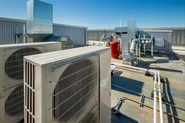 Neal HVAC technician servicing a rooftop commercial HVAC unit for a Georgetown business property