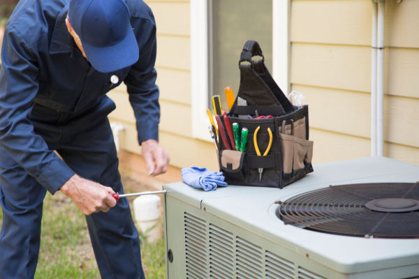 HVAC technician inspecting a heating system inside a Georgetown home during cooler weather