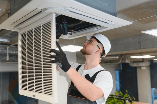 Neal HVAC technician completing routine HVAC maintenance on indoor and outdoor equipment in Georgetown