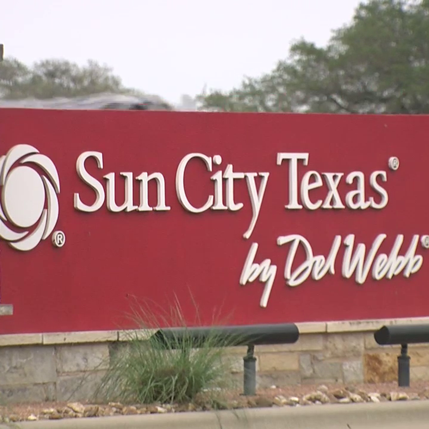 Technician repairing struggling AC unit during hot afternoon at Sun City Texas home