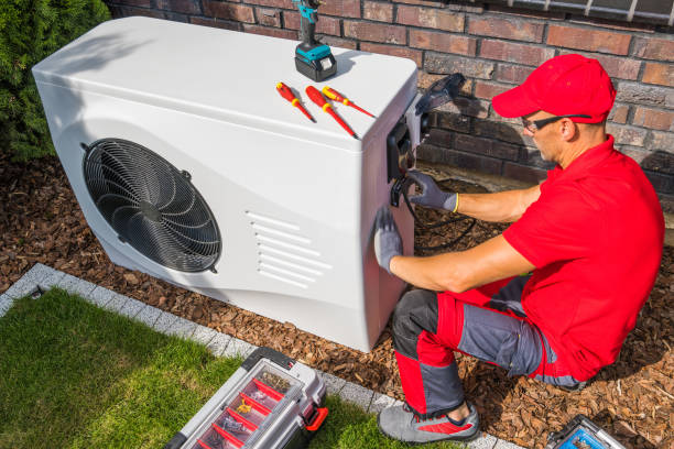 Skilled technician testing AC electrical and airflow performance with professional diagnostic tools