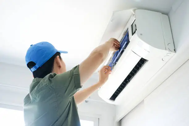 Experienced technician testing voltage and airflow to pinpoint residential cooling system issue